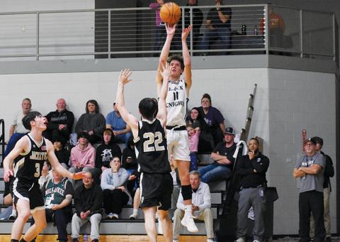 Black Knights senior Donovan Carpenter unloads a  corner jumper during the second half of Friday’s win over Hayesville. Carpenter’s 14-point evening led Robbinsville’s output. Photos by Fala Welch/The Graham Star