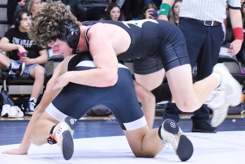 Robbinsville's Christian Koeller leaps into position for top control during Saturday's first-round match against Mountain Island Charter. Photo by Kevin Hensley/sports@grahamstar.com