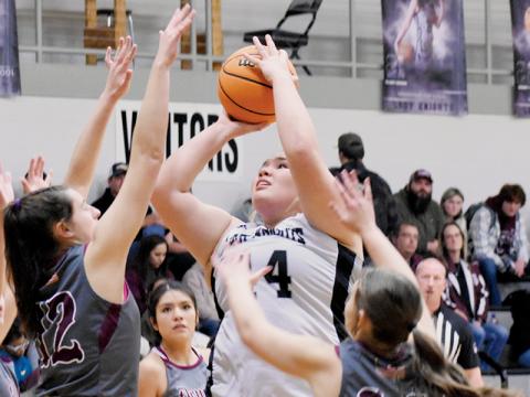 Senior power forward Aubrie Wachacha was not fazed by Swain County’s Carley Teesateskie (12) and  Molleigh Woodard (14) while putting up this inside shot Tuesday night. Photo by Fala Welch/The Graham Star
