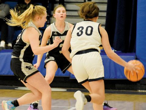 Robbinsville’s Novie Dutcher (left) and Abby Wehr close in for a corner trap on  Nantahala’s Zoey Passmore during the Lady Knights’ Jan. 11’s road win. Photos by Fala Welch/The Graham Star