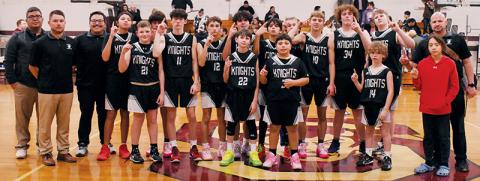 The Robbinsville Middle School Black Knights gathered at half court in Bryson City on Monday to commemorate a 14-0 regular season after defeating Swain County in the finale. Photos by Kevin Hensley/sports@grahamstar.com