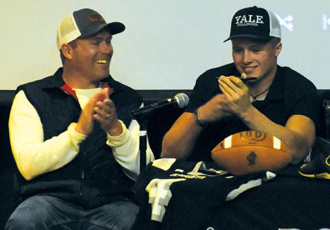 As his father Coy celebrates, Cuttler Adams speaks on the phone with Yale head coach Tony Reno, who helped Adams announce his college selection at a special Feb. 7 signing. Photos by Kevin Hensley/sports@grahamstar.com