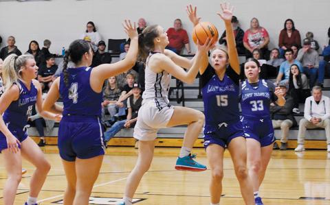Junior guard Claire Barlow fearlessly drives through four Hiwassee Dam defenders – Katie McNabb, Brinkley Payne, Olivia McNabb and Sky Taylor (from left) – in the second half of Jan. 25’s home game with the Eagles. Photos by Fala Welch/The Graham Star