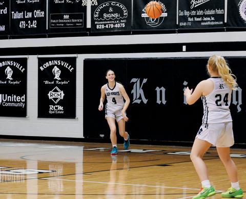 It was smiles all around for the Lady Knights during their regular-season home finale Feb. 7 against Blue Ridge School, as clearly illustrated on this throw-in from Claire Barlow (4) to Suri Watty. Photo by Audrey Colvin/The Graham Star