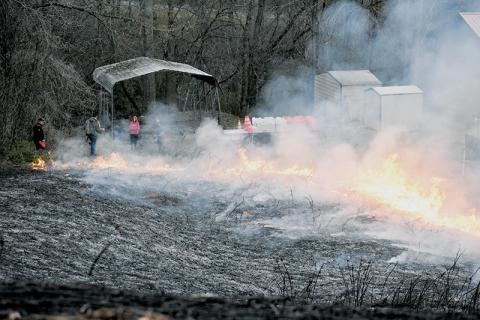 As part of a training exercise, the Graham County Fire Department conducted a controlled burn on a kudzu patch behind the EMS base off West Fort Hill on March 25. Though this fire was monitored from the get-go, brush fires being set across the county have proved difficult to maintain in recent weeks. Photo by Kevin Hensley/editor@grahamstar.com