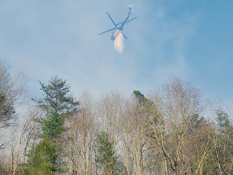 A fire that broke out Sunday afternoon in the Santeetlah area required the use of helicopters to help fight the flames overhead. Photo courtesy of Tory Lynnes/U.S. Forest Service