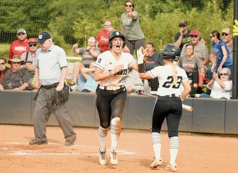 Members of the East Wilkes faithful pleaded their case, but Robbinsville junior Liz Carpenter was all fired up as she greeted Suri Watty after being called safe on a game-tying slide in Game 2 of the Western Regional Final Series on Friday. The deadlock was the closest the Lady Knights came to leading in the contest, as the Lady Cardinals went on to collect the victory and advance to the state finals. Photos by Jacquline Gayosso/The Graham Star