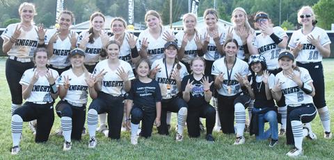 Although the Robbinsville Lady Knights wrapped up their 16th Smoky Mountain Conference title one day prior, the players wanted to signify their 7th-straight divisional crown by gathering in the outfield moments after sweeping the regular-season series against Murphy on May 2. Photo by Kevin Hensley/sports@grahamstar.com