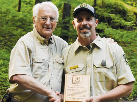 Richard “Dick” Evans (left) was surprised by Heath Emmons with the U.S. Forest Service and the Partners of Joyce Kilmer-Slickrock Wilderness on Monday with the Region 8 Volunteer of the Year Award. Photo by Kevin Hensley/editor@grahamstar.com
