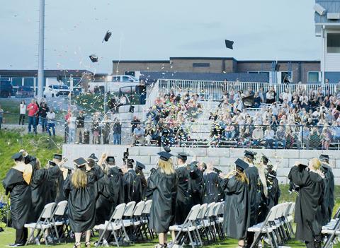 Caps, confetti, and Silly String began to litter the evening sky Friday, as the Robbinsville High School Class of 2024 launched a celebration at the end of the annual commencement exercise on Bob Colvin Field at Modeal Walsh Memorial (Big Oaks) Stadium. Photos by Kevin Hensley/editor@grahamstar.com