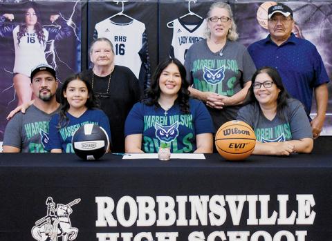 Fresh off high school graduation two months ago, Aubrie Wachacha solidified her immediate plans for the future by signing to play both volleyball and basketball at Warren Wilson College. Sitting with Wachacha are father Randy Wachacha (left), sister Amara Wachacha and mother Monaka Wachacha. Standing in back (from left) are grandmother Carolyn Wachacha, plus Debbie and John Bird. Photo by Kevin Hensley/sports@grahamstar.com