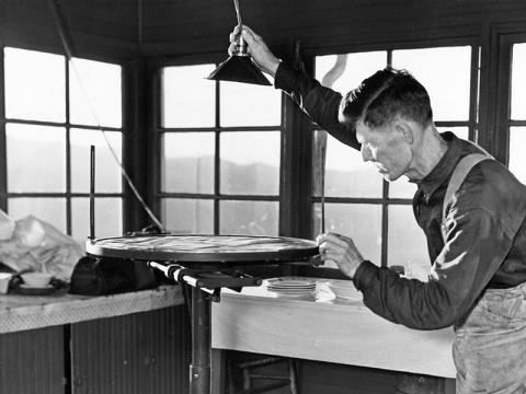 Ferd Colvin in the Hemlock Fire Lookout, c. 1930. Photo courtesy of Pam Hall Mathews/Charles Hall Museum and Heritage Center