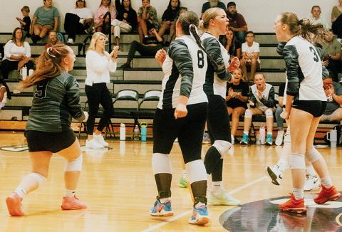 Robbinsville’s seniors Olivia Lewis (9), Liz Carpenter (center) and Claire Barlow (3) celebrate Barlow’s stout block in the closing moments of set one Monday against T.C. Roberson. The Lady Knights swept the Lady Rams in the season premiere. Also pictured on the court is Ryn Hooper (8); Daphne Barlow is behind Claire. Photo by Royce Worbington/The Graham Star