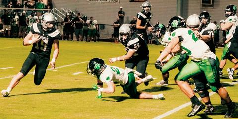Roman Jones (15) looks for some open room during Friday’s loss to Mountain  Heritage. Jones scored both of Robbinsville’s touchdowns in the game. Photos by Royce Worbington/The Graham Star
