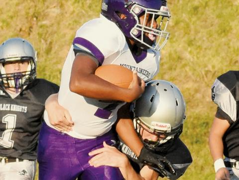 Eli Lambert wraps up a would-be Mitchell rusher during Aug. 22’s season opener. Lambert snagged the game-winning touchdown catch last week at Mountain Heritage. Photo by Jacquline Gayosso/The Graham Star