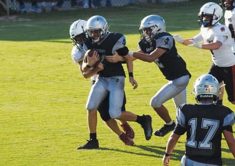 Landon Pollard attempts to shirk an Andrews defender Sept. 19. Elijah Kirkland (12) offers a helping hand for the cause. Photo by Jacquline Gayosso/The Graham Star