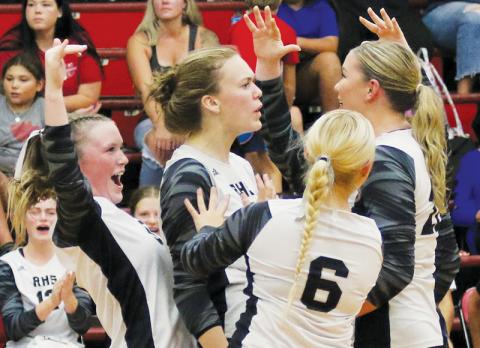 The Robbinsville Lady Knights celebrate after winning a hard-fought volley Aug. 29 at Andrews. Visible are Daphne Barlow (left), Claire Barlow, Suri Watty (6) and Liz Carpenter. Photo by Cannon Crompton/Cherokee Scout