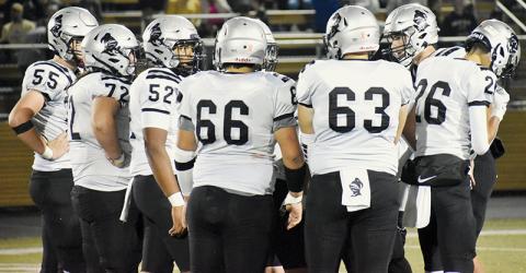 Bryce Adams (right) presents the next play to his offensive linemen and tackles during Friday’s game at Hayesville. Adams launched a trio of touchdown passes in Robbinsville’s win. Also pictured are Kasen Buchanan (55), Tytan Teesateskie (72), Kyzik Teesateskie (52), Jonah Teesateskie (66), Avery Webster (63) and Tucker Jones (26). Photo by Cheyanne Geyer/The Graham Star