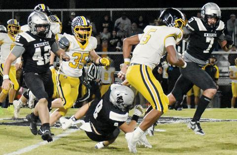 Under heavy pursuit from Ryelon Waldroup (42) and Isiac Collins (7), Murphy’s Cameron Clem sees his progress slowed drastically after Robbinsville senior Caden Lail (8) opts for a low tackle. Photos by Alex Parton/The Graham Star