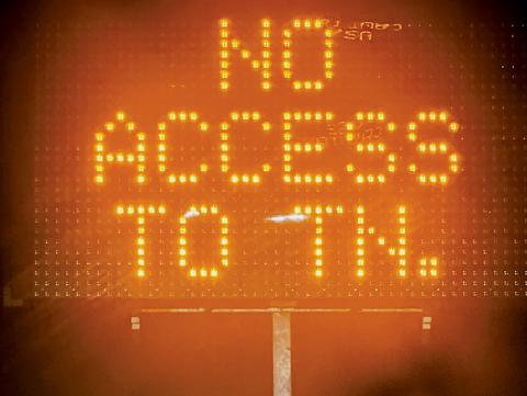 Following the closure of I-40 between North Carolina and Tennessee, tractor-trailers have met numerous warning signs – such as this one, at the intersection of N.C. 28 and N.C. 143 in Stecoah – to provide notice that U.S. 129 in Tennessee (the “Tail of the Dragon”) does not allow commercial vehicles over 30 feet. Photo by Kevin Hensley/editor@grahamstar.com