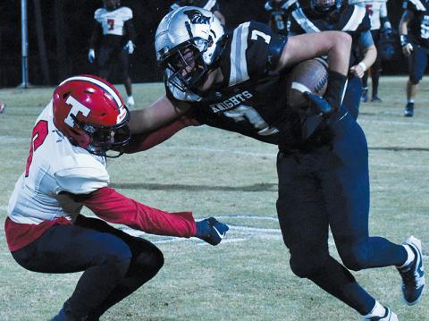 Junior fullback Isiac Collins (7) decisively denies Thomasville’s Elijah McNeair with a stiff-arm during Friday’s first-round playoff win over the Bulldogs. Photo by Bella Eddings/The Graham Star