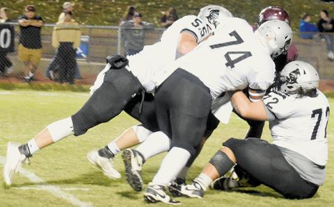Kasen Buchanan (55), John Dominguez (74) and Tytan Teesateskie (72) crunch Swain County’s Zeke Glaspie for a loss in the first half of Friday’s shutout over the Maroon Devils. Photos by Kevin Hensley/sports@grahamstar.com