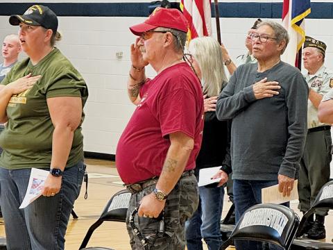 Amanda Gyongyos and Jim Huffman (front row), plus David Crowe and Sharon Crowe (back) stand to sing The Star-Spangled Banner at Friday’s Robbinsville High School Veterans’ Day program. Photos by Latresa Phillips/The Graham Star