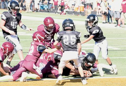 The expression concerning football being a “game of inches” was illustrated nicely by Robbinsville Mites quarterback Kyson Carpenter on Saturday, as the 11-year-old stretched to break the plane and give the Black Knights another Cracker Bowl title. Photos by Kevin Hensley/sports@grahamstar.com