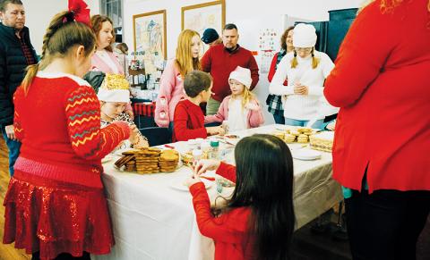 Children and adults alike gather to decorate cookies Saturday at Stecoah’s Christmas in the Mountains. Photos by Royce Worbington/The Graham Star