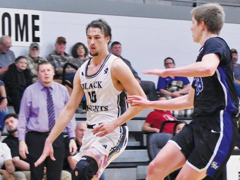 Bryce Adams attempts to dribble around Smoky Mountain’s Custer Pregner during Monday’s home opener. Adams has led Robbinsville’s scoreline in three of the Black Knights’ first four games this season. Photo by Bella Eddings/The Graham Star