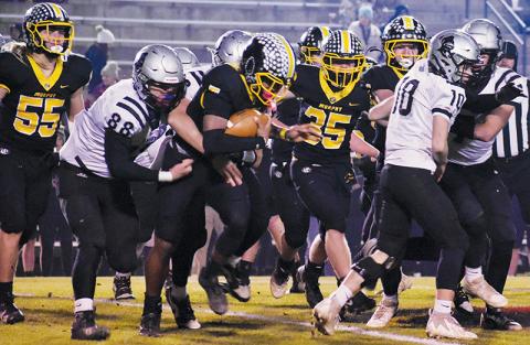 Amidst a first-quarter scrum, Robbinsville’s Kasen Buchanan (88) wraps up  Murphy’s Cameron Clem during Friday’s third-round playoff game. Photo by Bella Eddings/The Graham Star