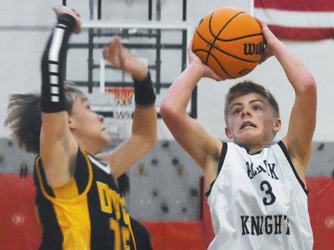 Middle school Black Knight Brayden Allison prepares to shoot around the defense of Murphy’s John Parker Watson during Monday’s loss to the Bulldogs. Photo by Kyla Garland/The Graham Star