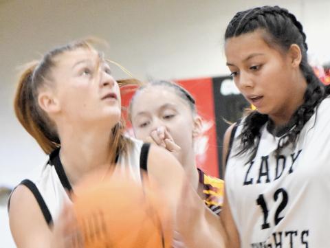 With Aaliyah Wolfe (12) running interference,  Robbinsville Middle’s Ella Nelms eyes a basket Monday against Cherokee. Photo by Bella Eddings/The Graham Star