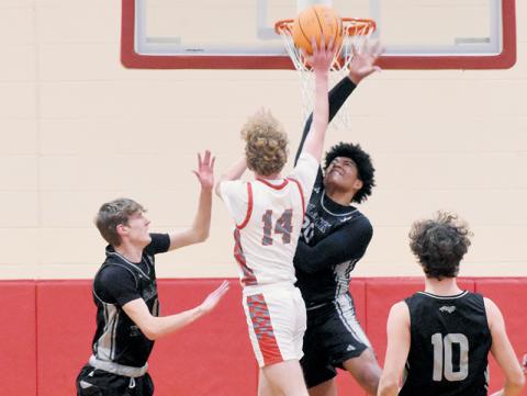 Robbinsville’s Kyzik Teesateskie (20) defies gravity to deny Copper Basin’s Talon Smith on Monday. Photos by Kevin Hensley/sports@grahamstar.com