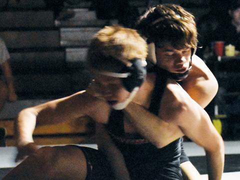 Skyler Anderson wraps up West-Oak’s Gunner Mease during the 106-pound finals of the James Orr Invitational on Saturday. Photos by Bella Eddings/The Graham Star