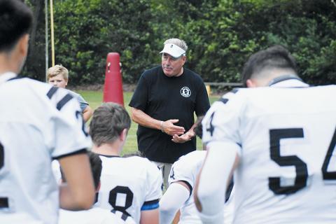 Dee Walsh gives one final pep talk before what proved to also be his final preseason scrimmage Aug. 16 at T.C. Roberson High School. After winning 189 career games in 22 seasons at his alma mater, Walsh announced he was stepping down as both head football coach and Robbinsville High School’s athletic director Friday. Photo by Kevin Hensley/sports@grahamstar.com