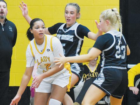 Robbinsville’s Anna Williams (5) and Suri Watty (23) trap Murphy’s Ilie Smith on Tuesday. Photos by Kevin Hensley/sports@grahamstar.com