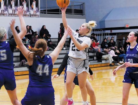 Suri Watty takes flight amongst the flocked defense of Lady Eagles Olivia McNabb (15), Bella Stiles (44), Sky Taylor and Abby Harris (21) on Jan. 14. Photo by Kyla Garland/The Graham Star