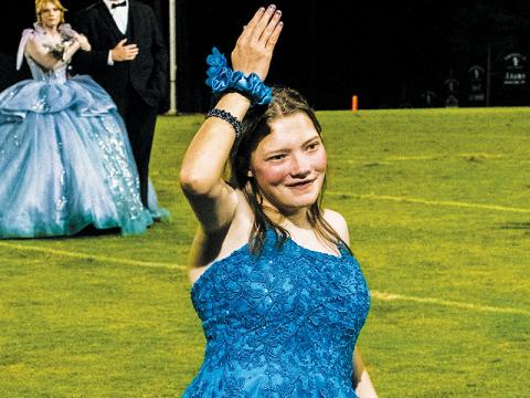 Robbinsville High School senior Shalimar Daniels soaks in the adulation of fans across Big Oaks Stadium on Oct. 4, after being introduced as an honorary attendant during homecoming. Photo by Royce Worbington/The Graham Star