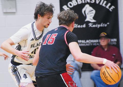 Robbinsville senior Bryce Adams – shown guarding Andrews’ Braxton Rickett on Friday – surpassed the 1,100-point mark for his career Monday against Summit Charter. Photo by Bella Eddings/The Graham Star