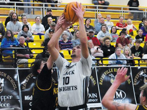 Bryce Adams looks to outmaneuver Murphy’s Connor Golden during the first half of Tuesday’s Smoky  Mountain Conference tournament semifinal. Adams  became the all-time scoring leader for Robbinsville Black Knights basketball in the game. Photo by Kevin Hensley/sports@grahamstar.com