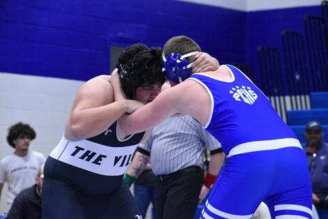 Robbinsville heavyweight Jonah Teesateskie (left) locks horns with Polk County's Brady Carroll during the third round of the 1A state duals Feb. 5. Teesateskie was 1-of-7 Black Knights to qualify for the individual state tournament. Photo by Kensie Belk/The Graham Star