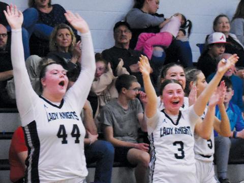 Members of the Robbinsville Lady Knights hit the floor to celebrate with their teammates after Tuesday’s conference win over Hayesville. From left are Bentley Riggins, Abby Wehr, Liz Carpenter and Anna Williams. Photos by Kyla Garland/The Graham Star