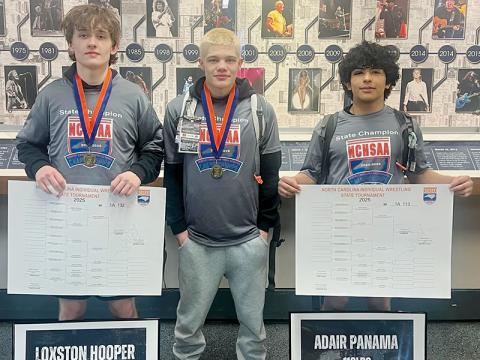 Loxston Hooper, Skyler Anderson and Adair Panama (from left) each conquered their respective brackets during the individual state tournament, bringing home three more gold medals for the reputable Black Knights’ wrestling program. Photo courtesy of Brooke Haney/Robbinsville Wrestling
