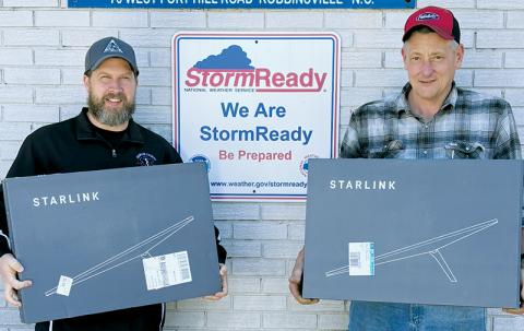 Graham County EMS Director Brian Stevens (left) and Graham County Fire and Rescue Commander Jeff Millsaps show off the Starlink routers donated through a fundraiser jumpstarted by local resident Judy Carpenter.