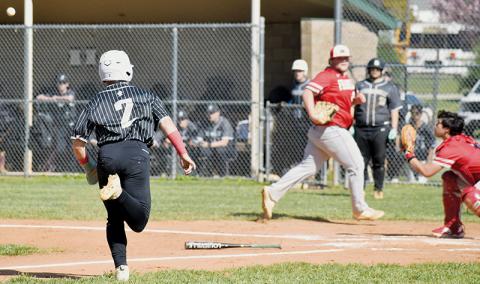 Robbinsville’s Easton Shuler (2) tries to beat the relay throw to home plate during Game 1 of April 9’s doubleheader against Franklin. Photo by Bella Eddings/The Graham Star