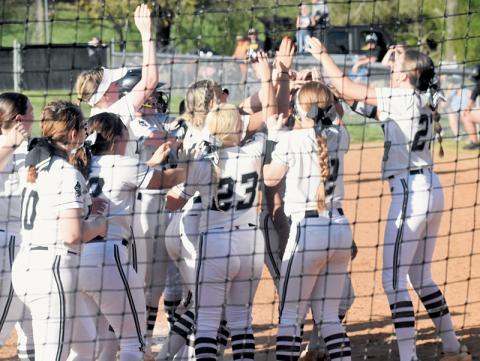Robbinsville senior Naomi Taylor gets lost in a sea of Lady Knight players Friday, as she was greeted at home plate following her go-ahead home run against Murphy. Photo by Lexie Anderson/The Graham Star