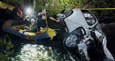 Members of the Graham County Fire and Rescue Squad work their way back to shore after rescuing James Vollmer following an accident that sent the area dentist into the Cheoah River on May 13. Photos courtesy of Graham County Fire and Rescue