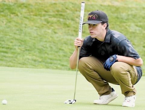 Avery Brown sizes up a putt April 24 at the conference tournament opener. Photo by Kevin Hensley/sports@grahamstar.com