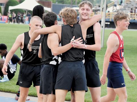Austin Bohn, Colton McCoy and Nathan Frederick greet Cameron Allison moments after Robbinsville's 4x400 relay team clinched third place at Friday's state meet. Photo by Kevin Hensley/sports@grahamstar.com